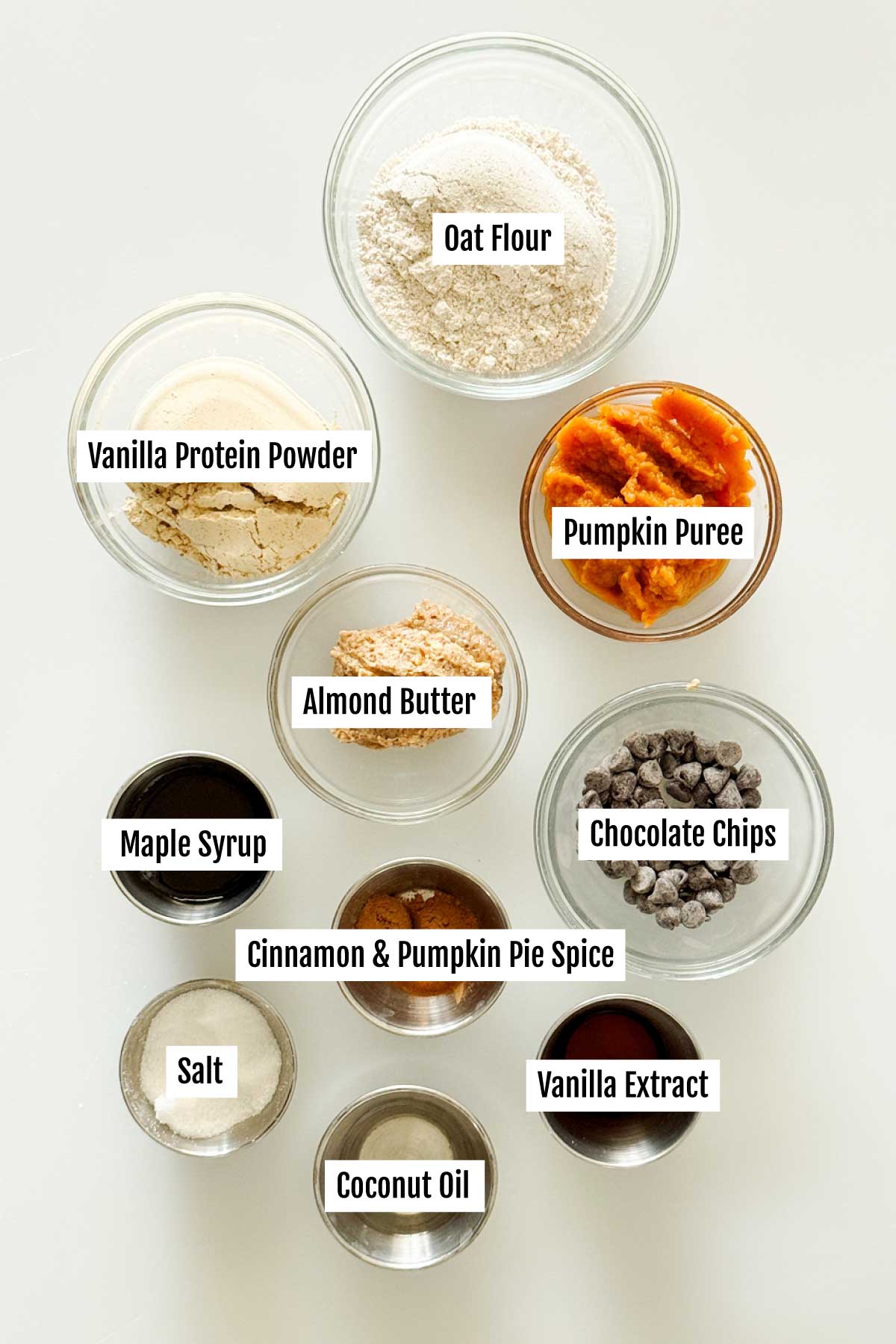 All the ingredients you need to make gluten-free chocolate pumpkin protein bars with chocolate drizzle on top and oat flour.