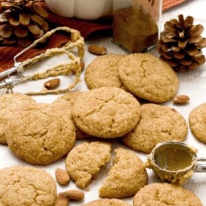 Gluten-Free pumpkin snickerdoodle cookies with almond flour and cinnamon stacked on parchment paper.