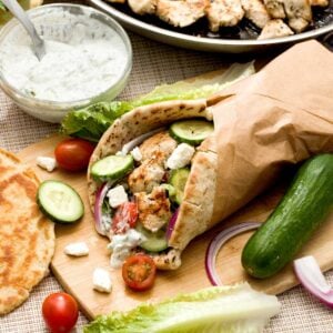 Feature image of Greek yogurt chicken breast gyros with homemade tzatziki sauce and optional gluten-free naan or pita bread.