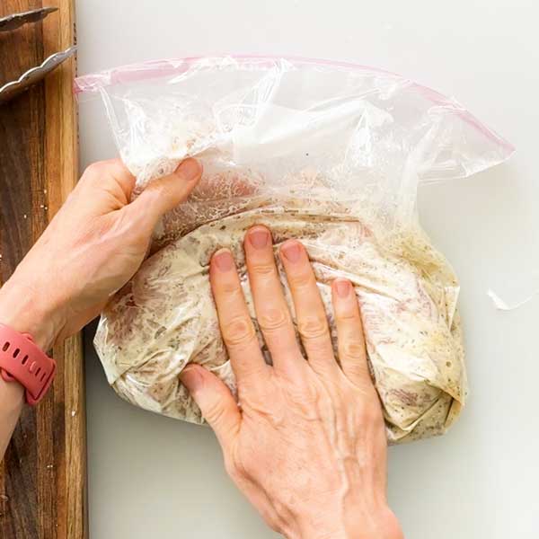 Marinating the chicken breast in the bag.