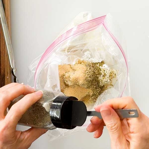 Adding the marinade ingredients to the bag.