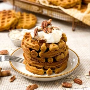 A stack of gluten-free protein pumpkin waffles with oat flour and greek yogurt.