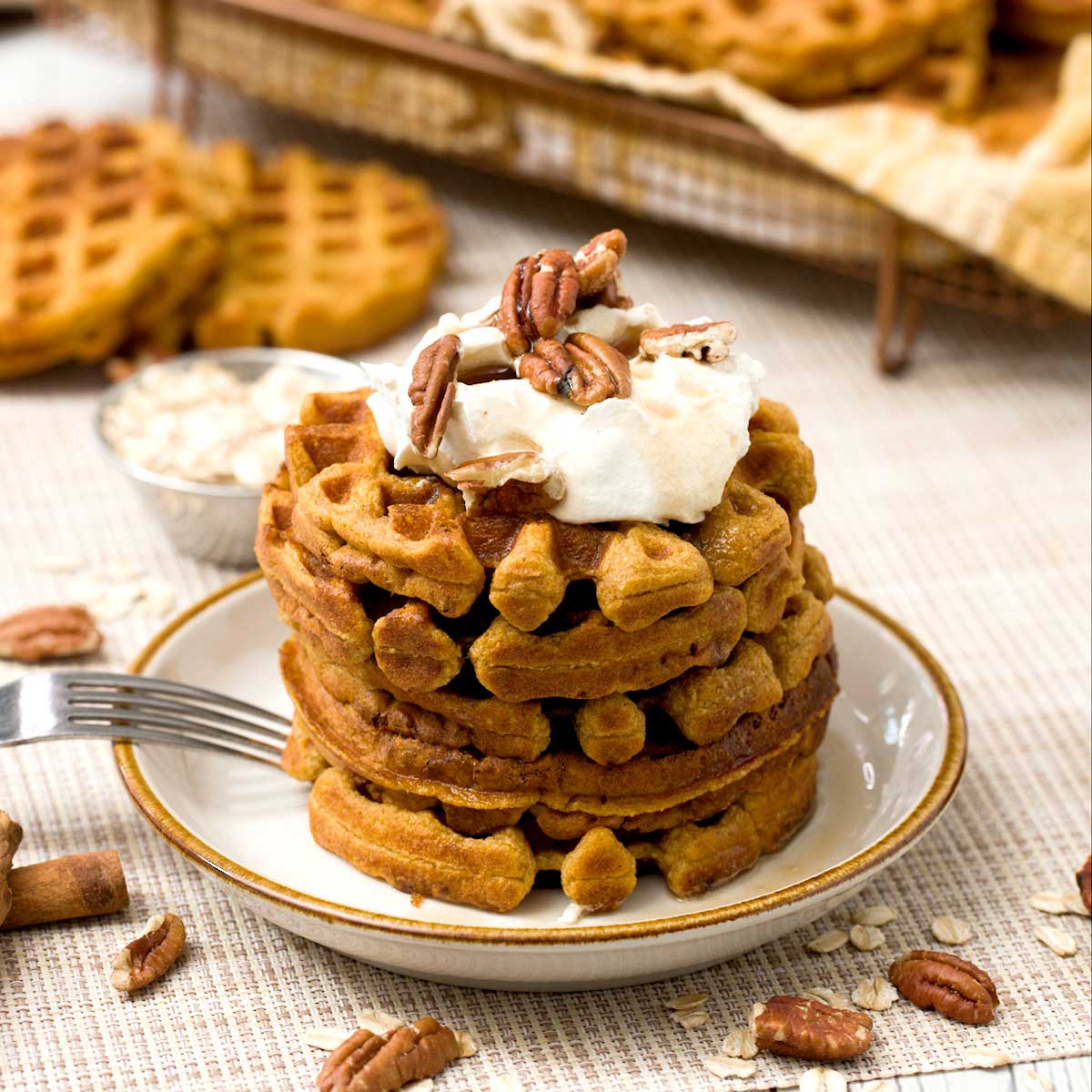 A stack of gluten-free protein pumpkin waffles with oat flour and greek yogurt.