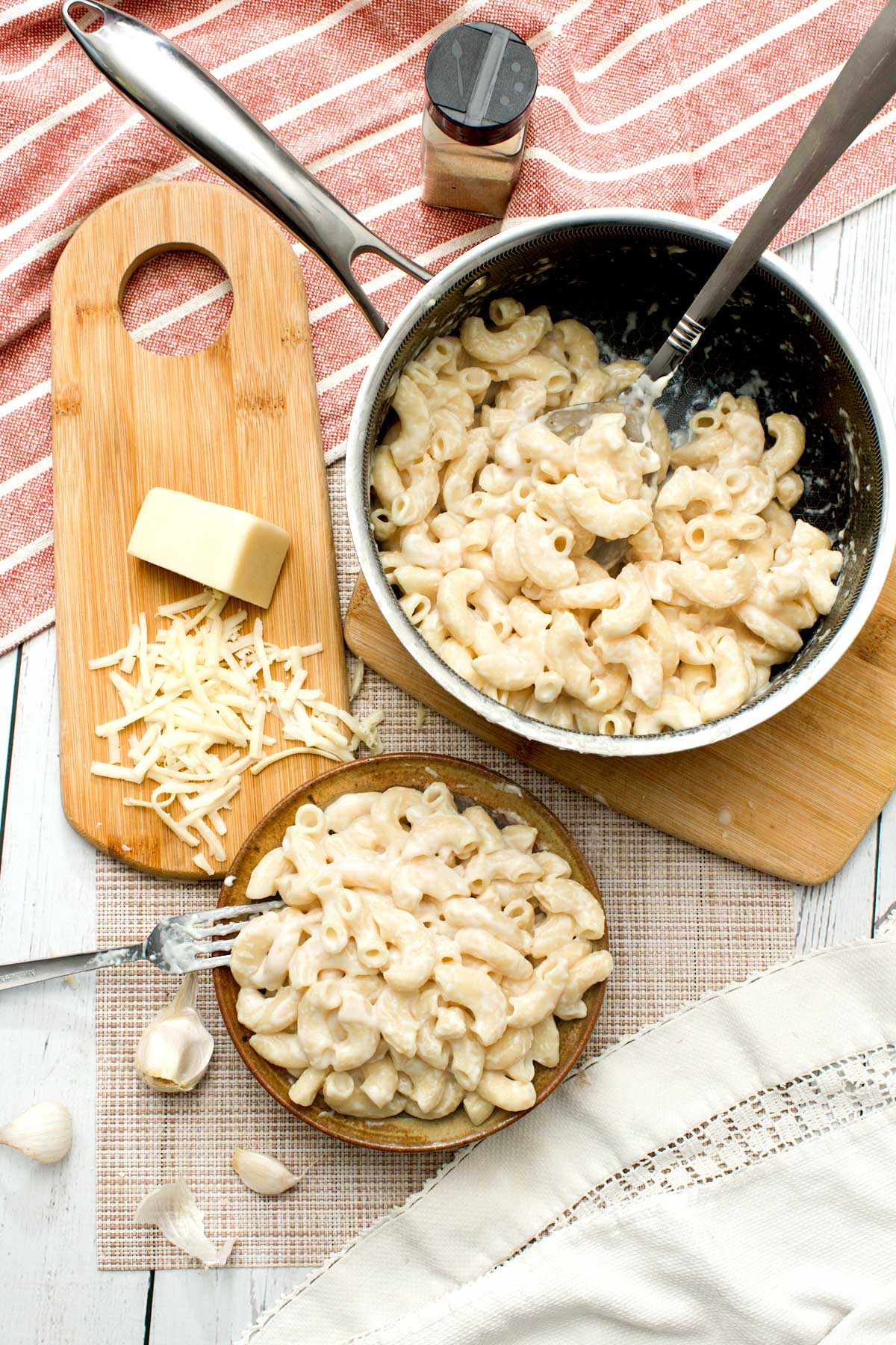 White cheddar mac and cheese with greek yogurt in a bowl and a sauce pan.