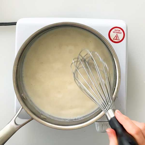 The sauce simmering and the cornstarch thickening.