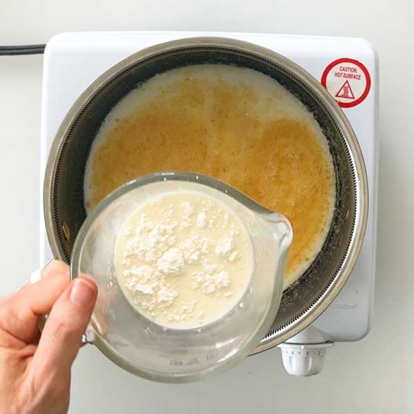 Stirring the cornstarch into the milk.