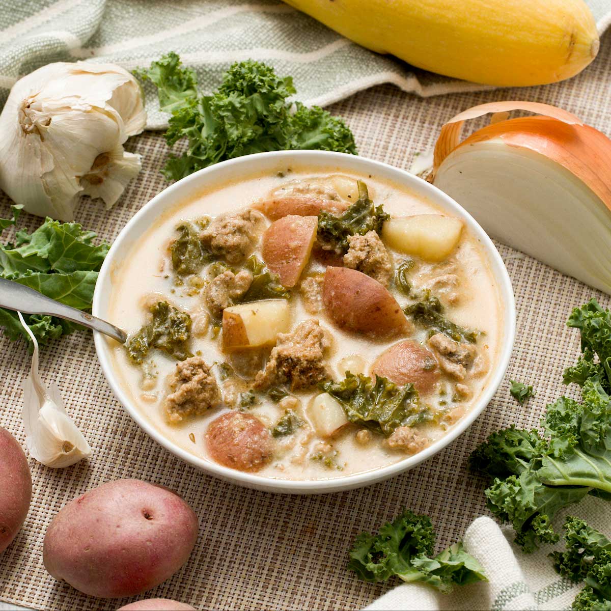 A bowl of healthy Zuppa Tuscana soup with ground turkey and greek yogurt with red potatoes.