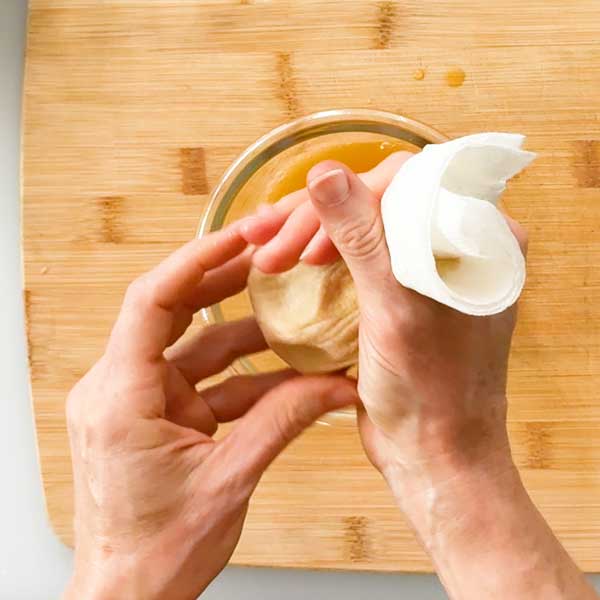 Squeezing the water out of the pumpkin puree.