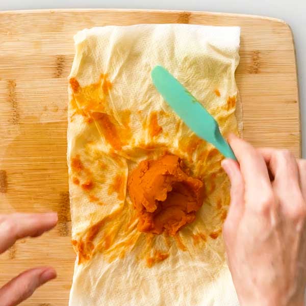 The strained pumpkin paste on a paper towel.