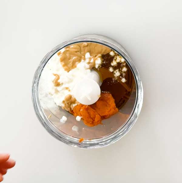 Adding all the wet ingredients to a chopper cup.