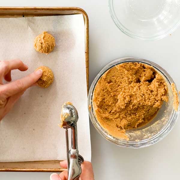 Scooping the truffles on the cookie sheet.