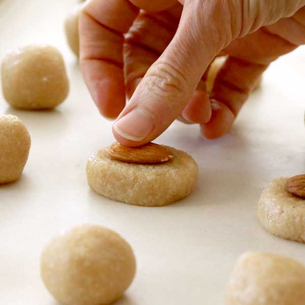 Placing an almond on top of the shaped bar.
