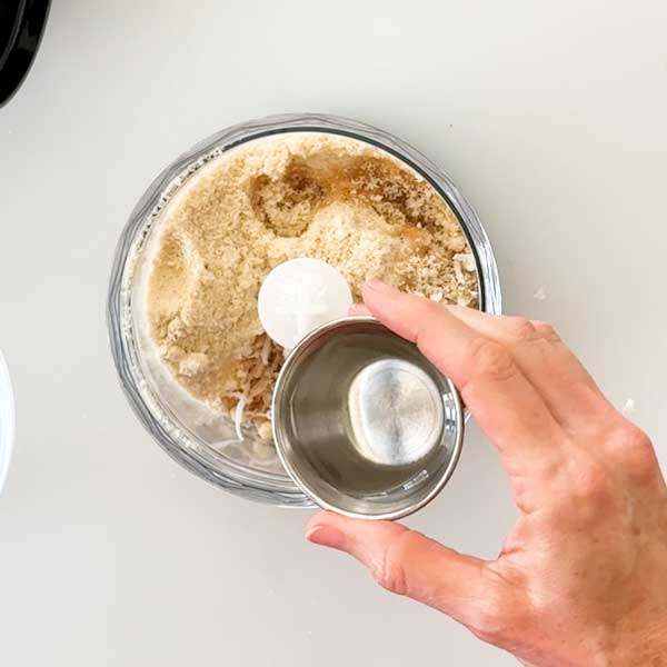 Adding the ingredients to a small chopper cup.