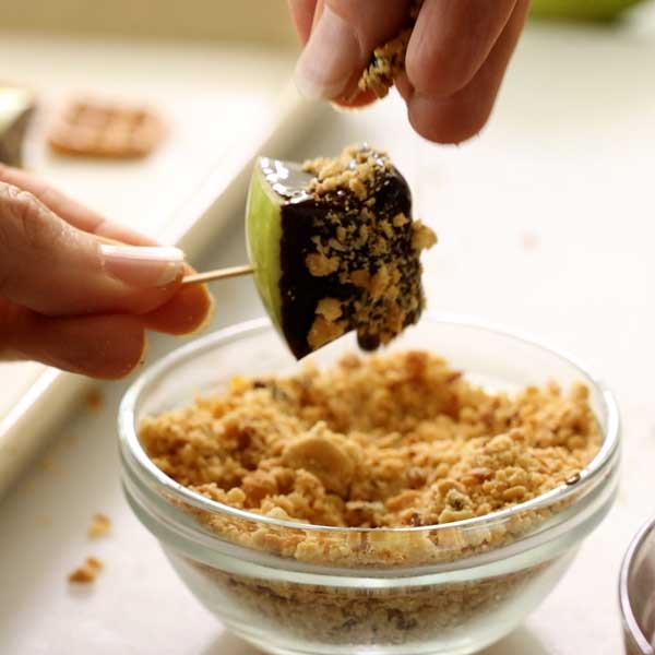 Sprinkling the crushed peanuts over the melted chocolate.