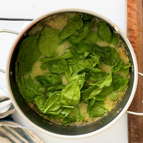 Adding the spinach and lemon to the soup.