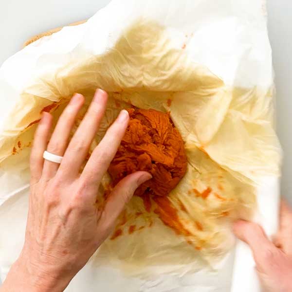 The strained pumpkin puree in the napkins.