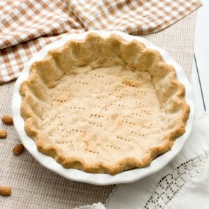 A gluten-free almond flour pie crust in a pie plate.