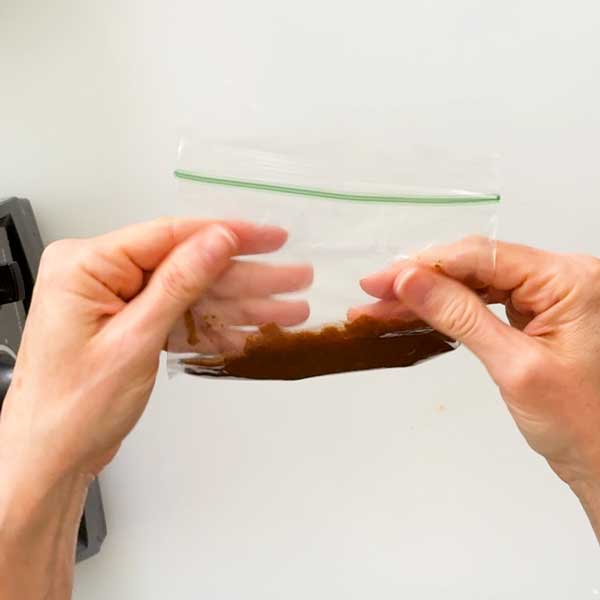 Adding the cinnamon butter mixture to a small snack bag.