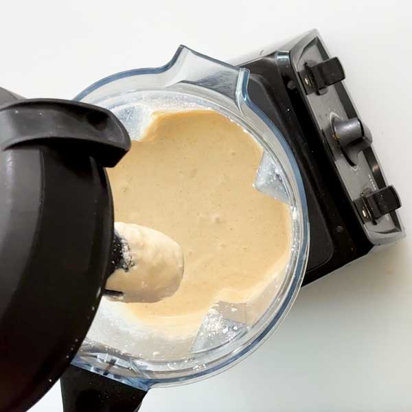 The blended pancake batter in a blender.