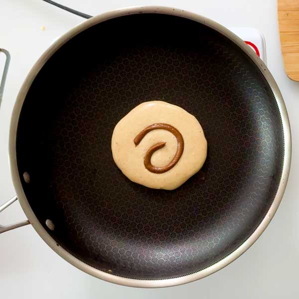 The pancake with a swirl of cinnamon butter on top.