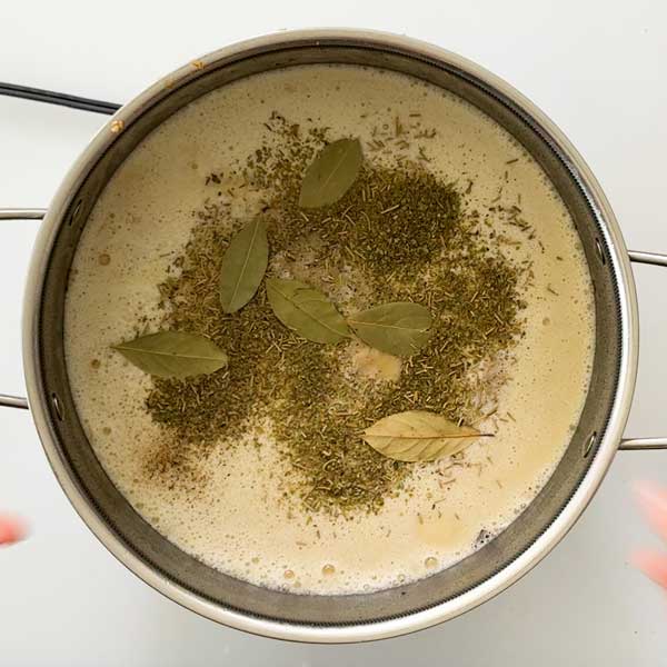 Adding the seasonings to the soup.