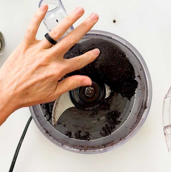 The cheesecake crust forming a ball of dough in the food processor.