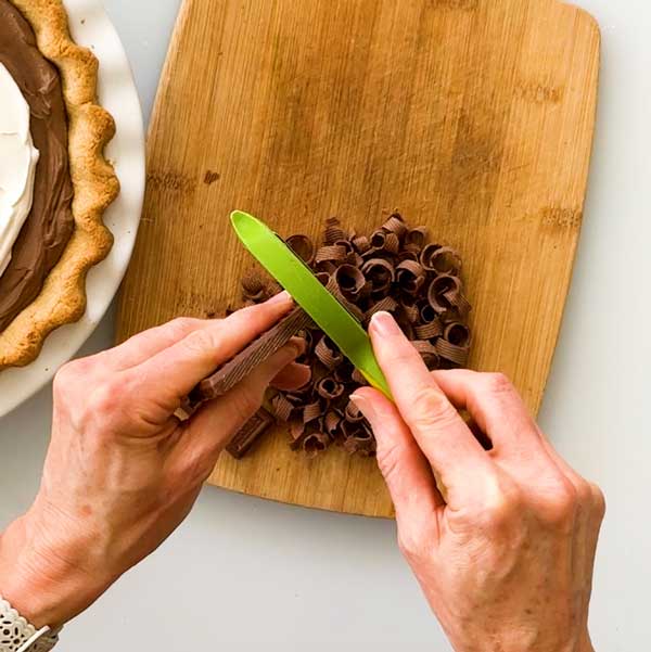 Making chocolate curls with a vegetable peeler.