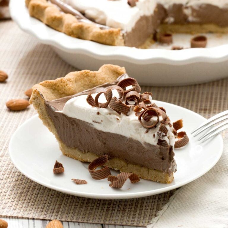 A gluten-free chocolate pie slice with an almond flour crust and chocolate cottage cheese filling.