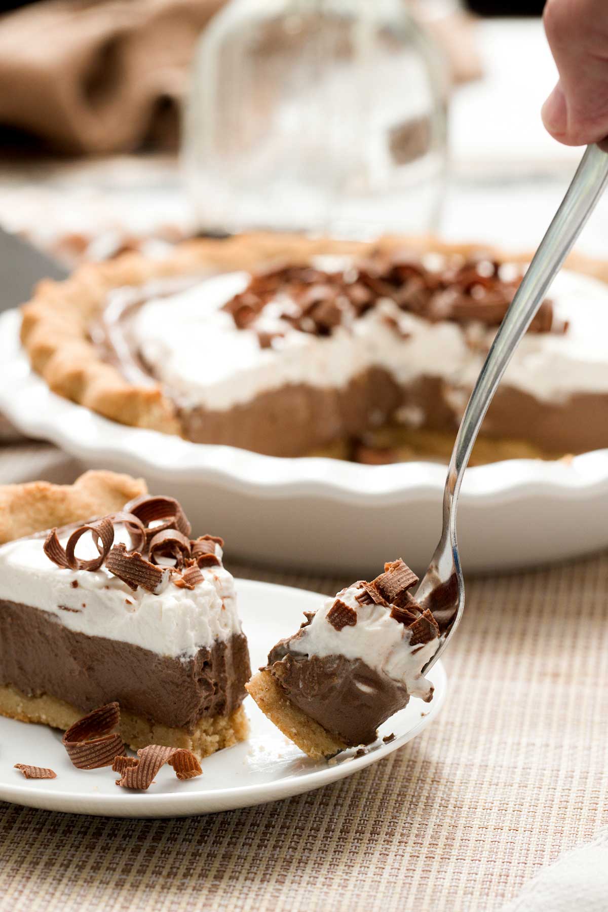 A slice of gluten-free chocolate pie with an almond flour crust and chocolate cottage cheese filling.