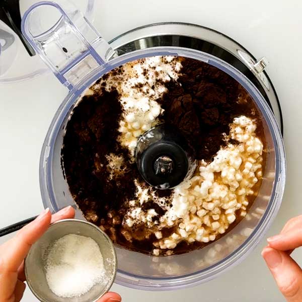 Adding the chocolate filling ingredients to a food processor.