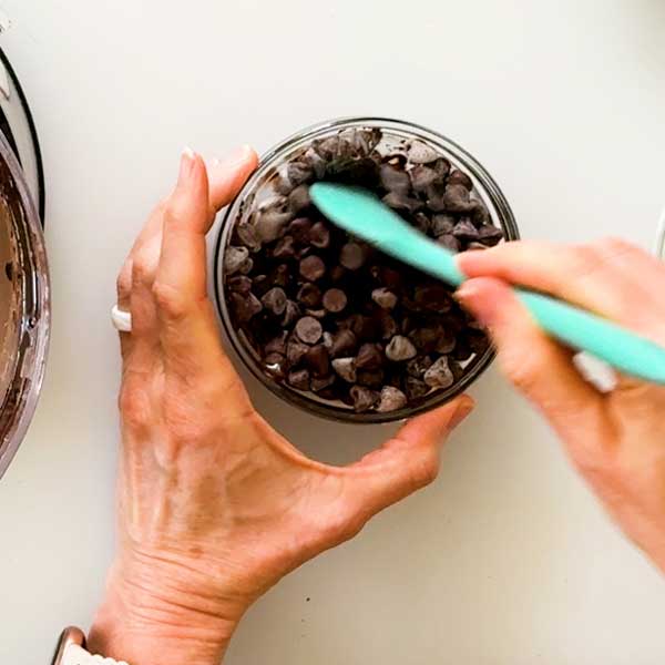 Stirring the melted chocolate chips in a bowl.