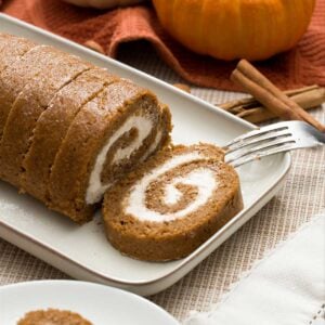 A healthy, gluten-free pumpkin roll with cottage cheese filling on a plate.