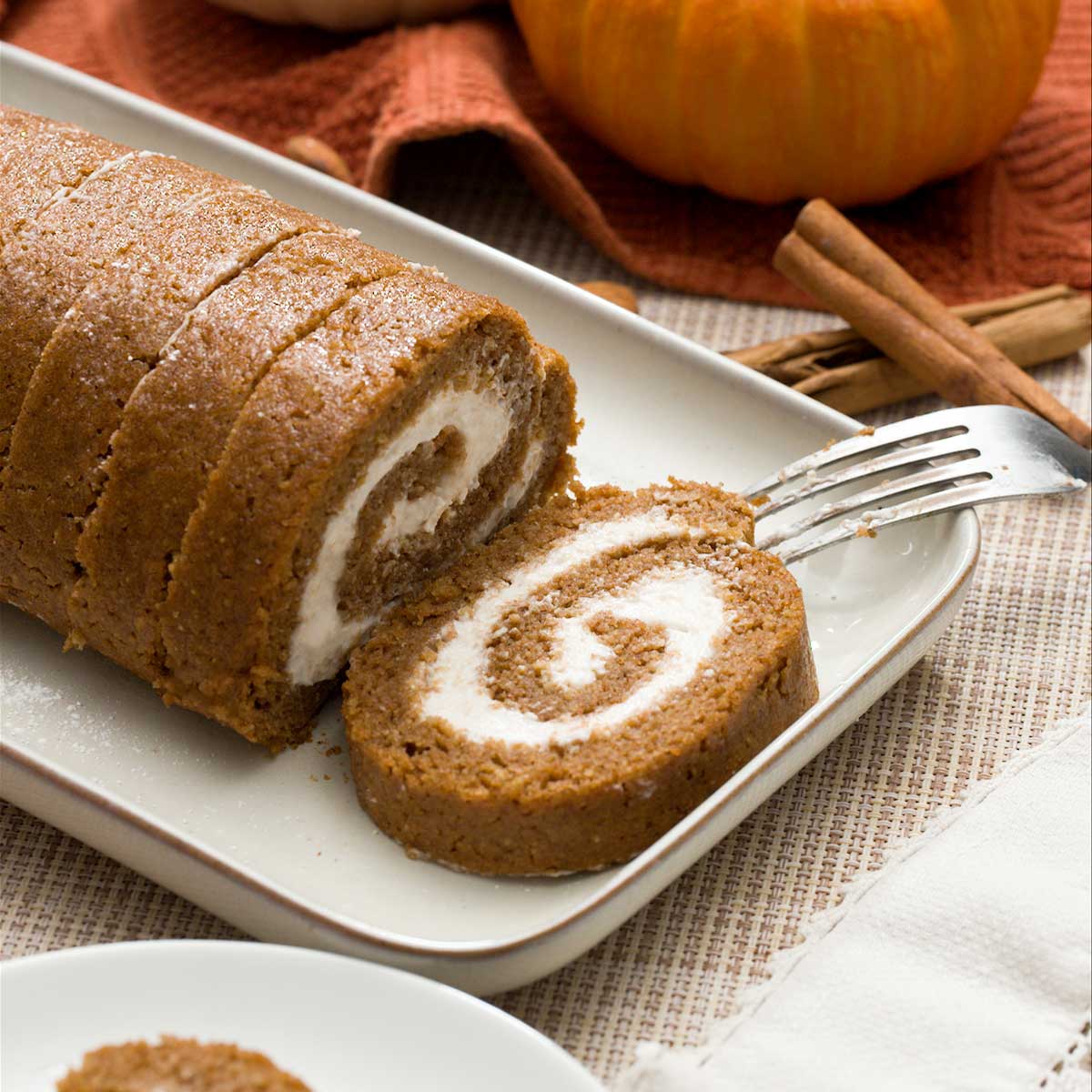A healthy, gluten-free pumpkin roll with cottage cheese filling on a plate.