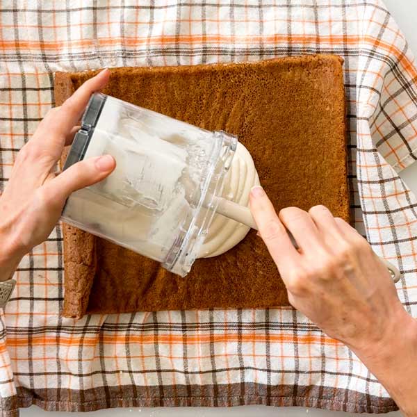Spreading the cottage cheese filling on the cake.