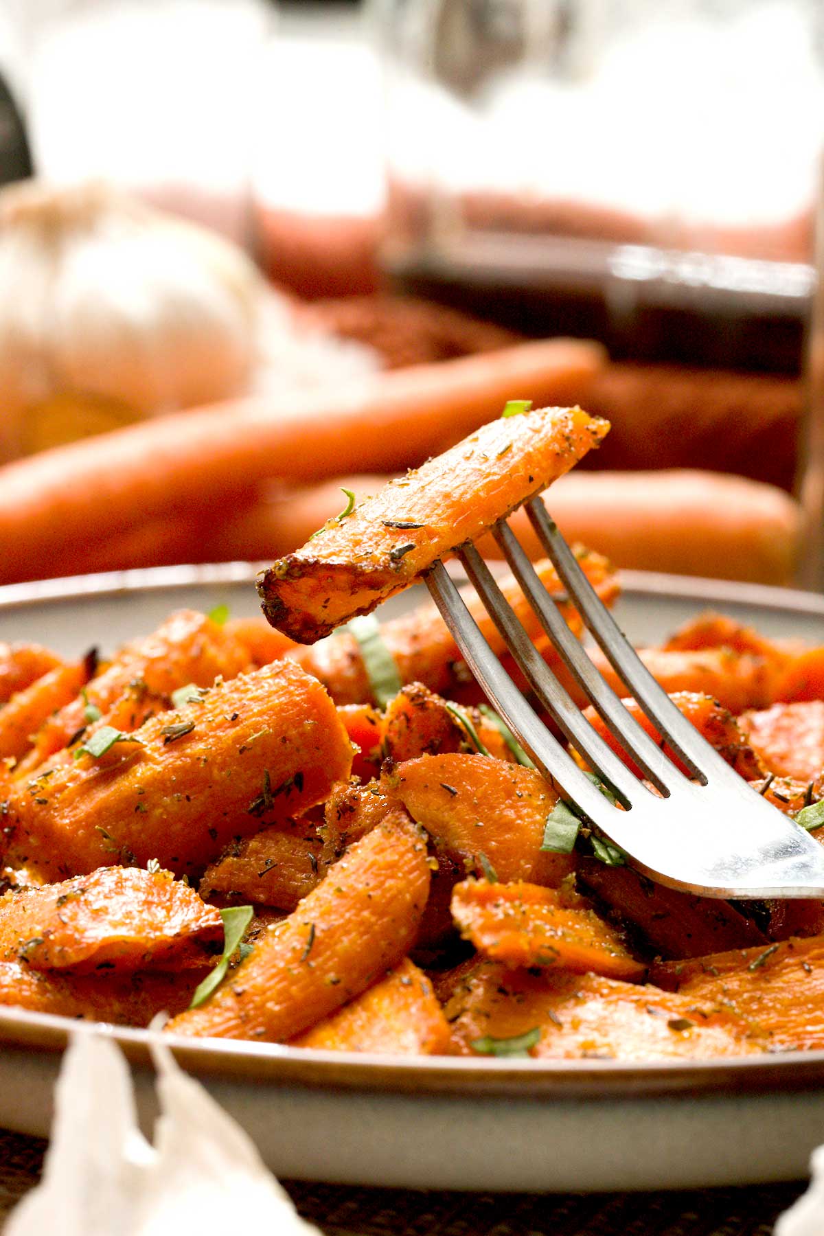 A fork with a maple glazed carrot on it.