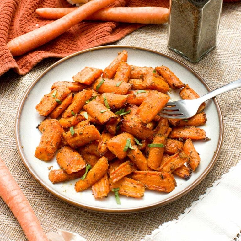 A plate of ealthy maple-glazed carrots cooked in an air fryer or oven.