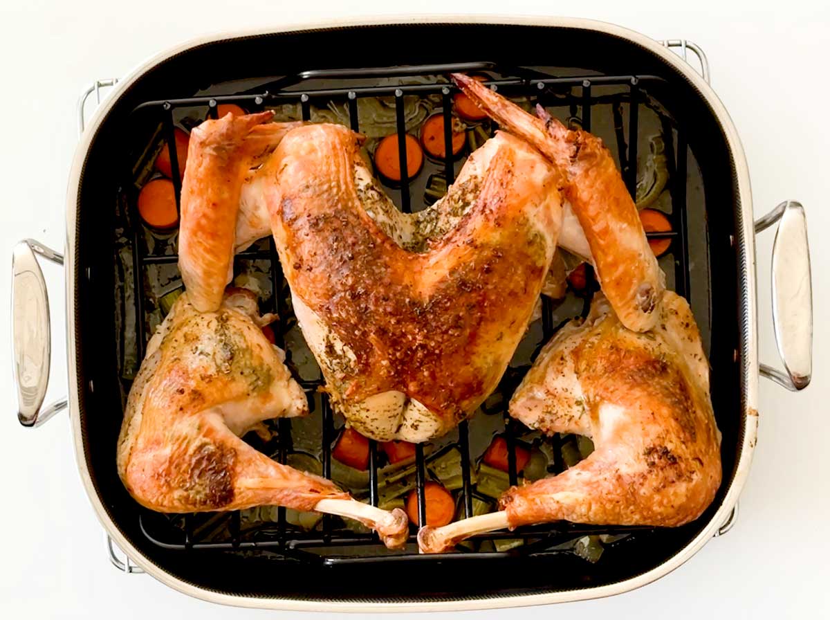 A roasted spatchcock turkey in a HexClad Hybrid Roasting Pan.