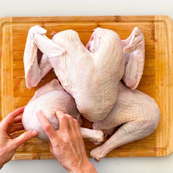 Cutting the turkey legs from the body.