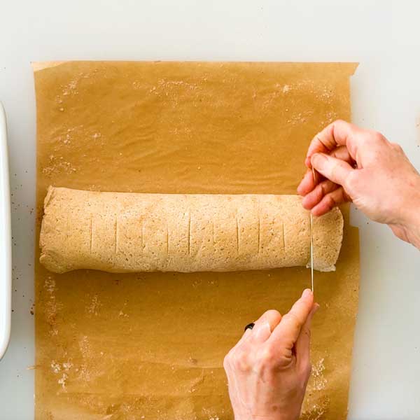 Slicing the cinnamon rolls with dental floss.