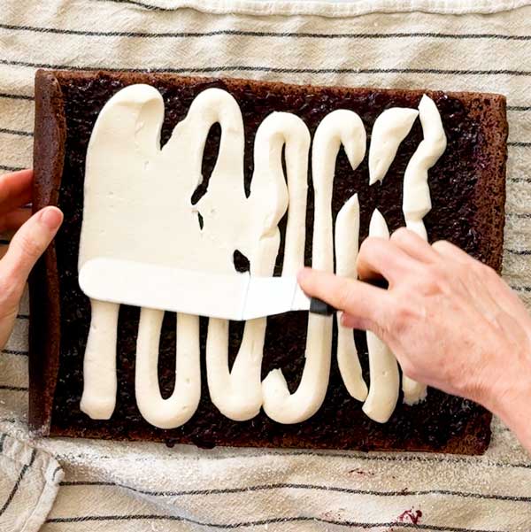 Spreading the cottage cheese filling with an offset spatula on the cherry compote layer.