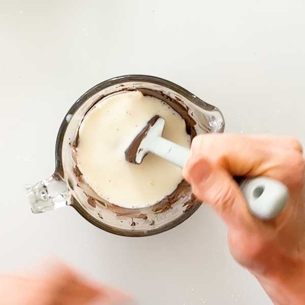 Stirring the milk into the chocolate ganache.