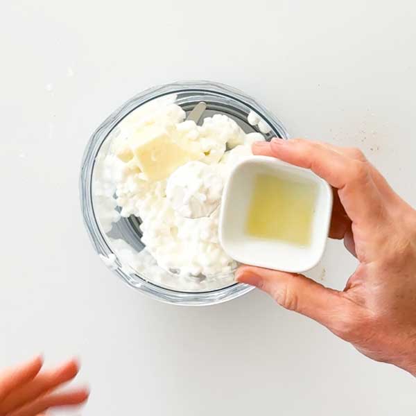 Adding cottage cheese filling ingredients to the chopper cup of an immersion blender.