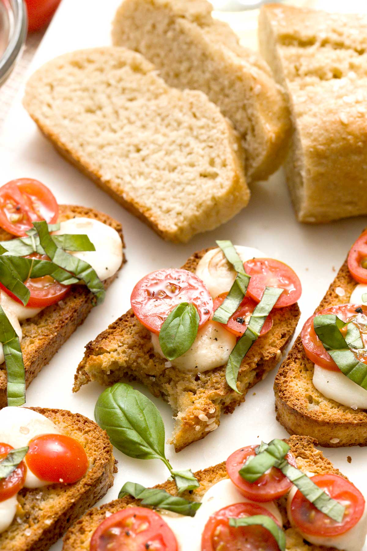 Close-up of gluten-free crostinis with tomato, basil, and mozzarella cheese.