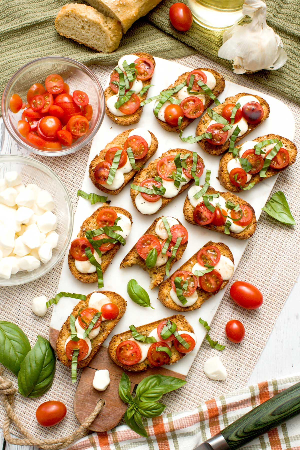 The top view of gluten-free crostinis with tomato, basil, and mozzarella cheese.