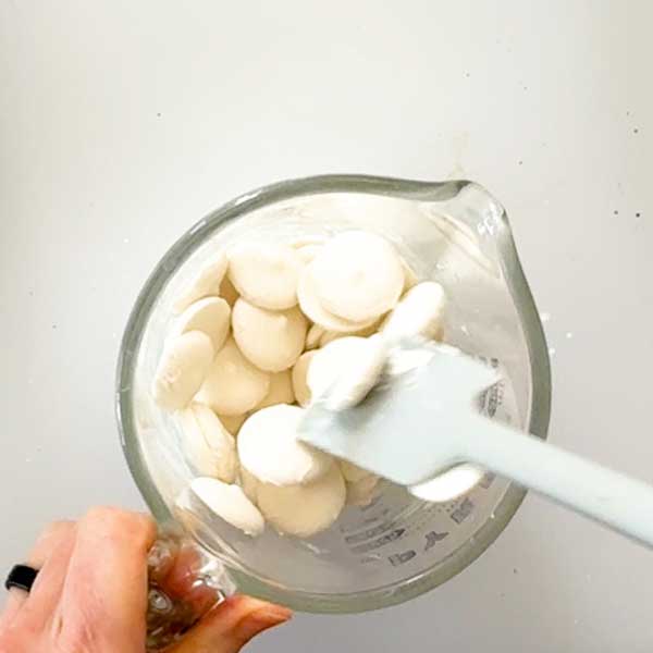 Stirring the melted white chocolate in a bowl.