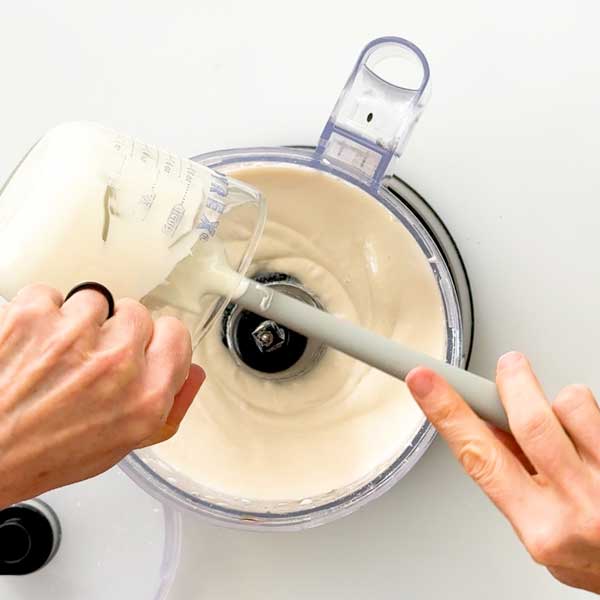 Pouring the melted white chocolate in to the filling.