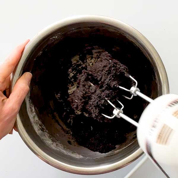 Mixing the pie crust dough with a hand mixer.