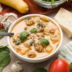 A bowl of healthy marry me chicken soup with greek yogurt with spinach and sun-dried tomatoes.