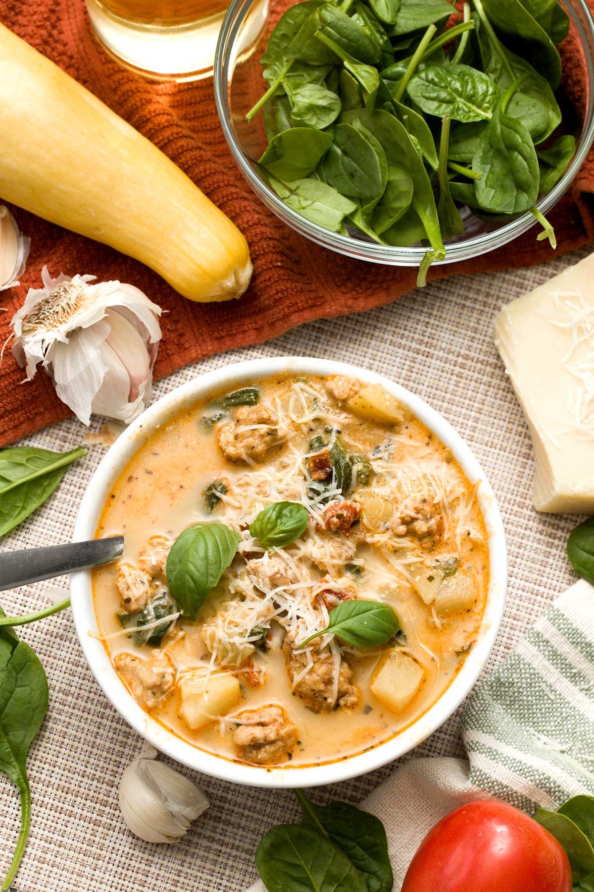 The top view of a bowl of healthy marry me chicken soup with greek yogurt with spinach and sun-dried tomatoes.