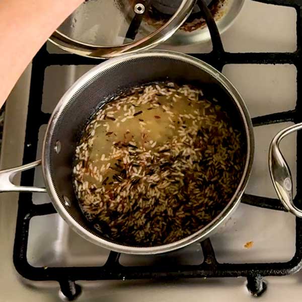 Adding all the rice ingredients to a separate small pot.
